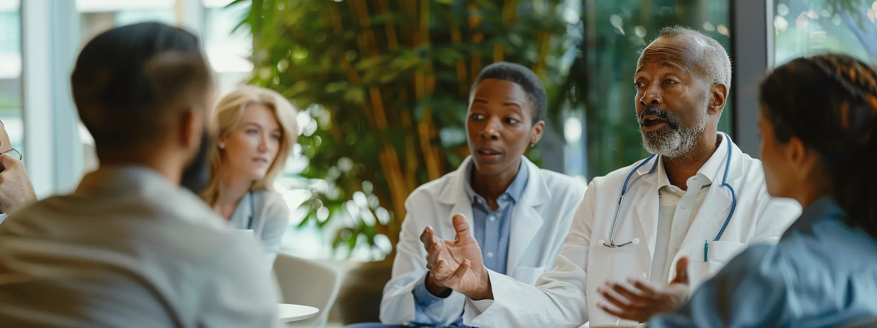 a doctor discussing content marketing and seo strategies with a group of colleagues in a modern office setting.