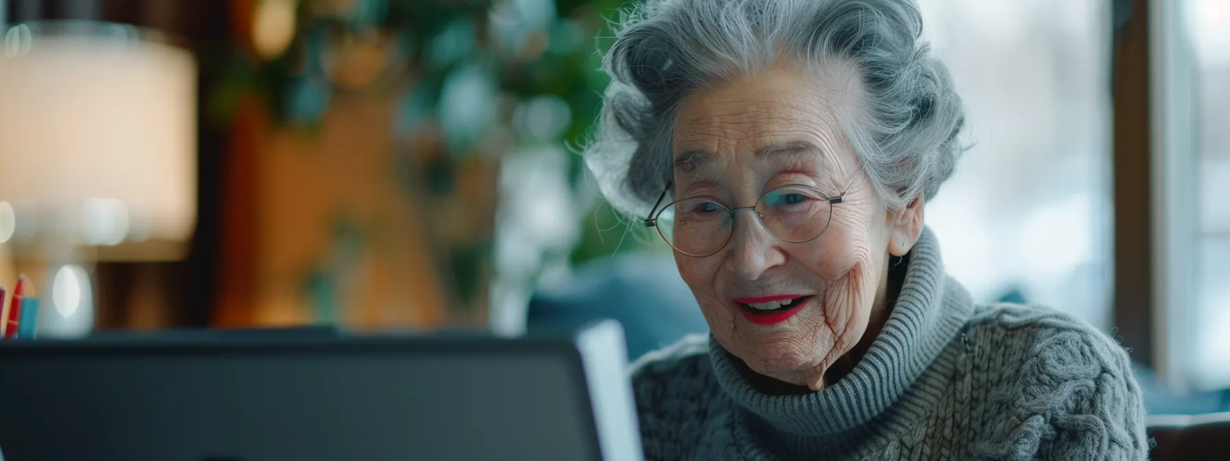 an elderly person smiling while browsing a fast-loading geriatrician practice website on a computer.