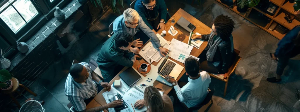 a diverse group of professionals collaborating around a table, brainstorming ideas and working together to drive a project forward.