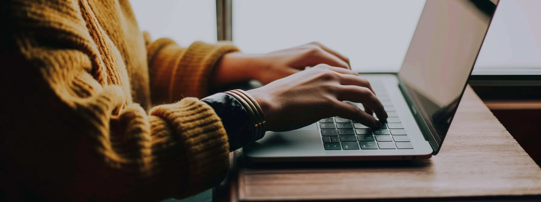 a person typing on a laptop with multiple tabs open, researching seo keywords in melbourne.